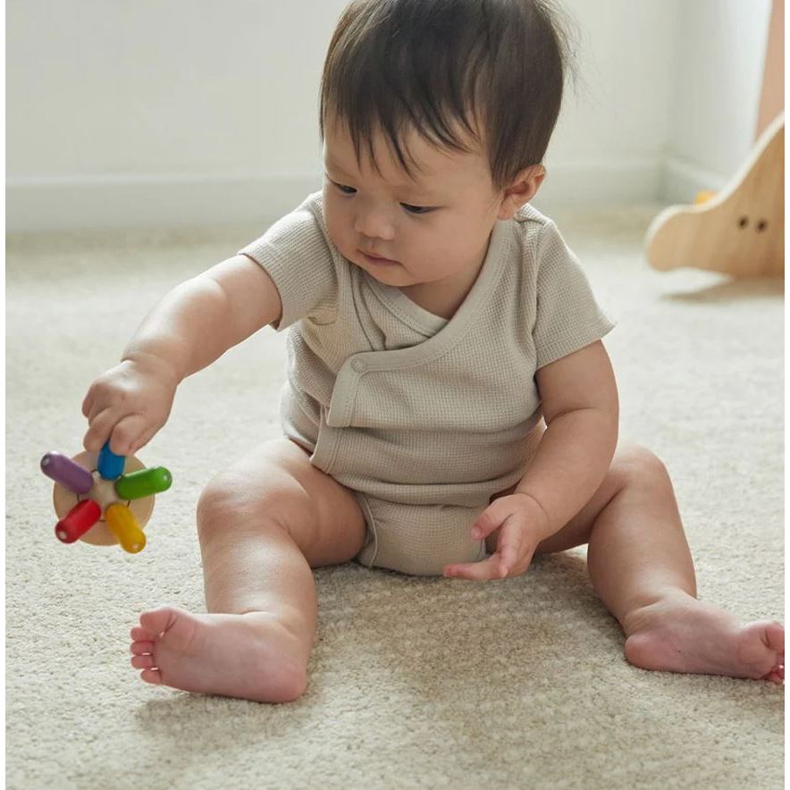 Baby playing with Plan Toys Flexi Jellyfish Baby Toy