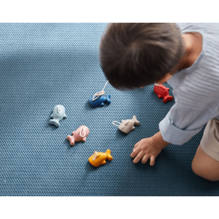 Image featuring young child playing with wooden toys