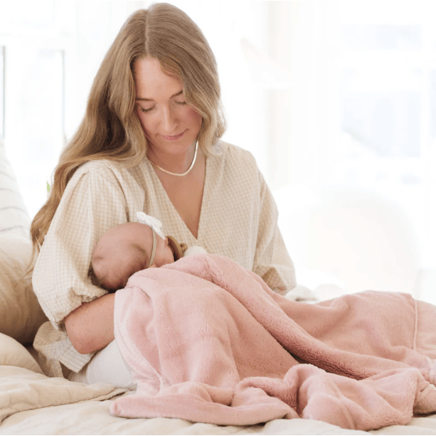 Mother with newborn baby cradling baby