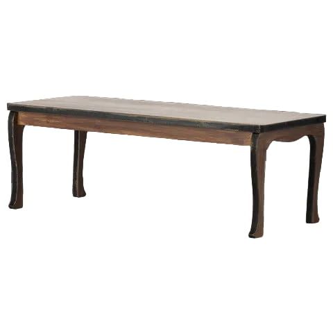 A rectangular wooden table with a dark brown carved frame and a light beige tabletop, shown against a gray and white checkerboard background.