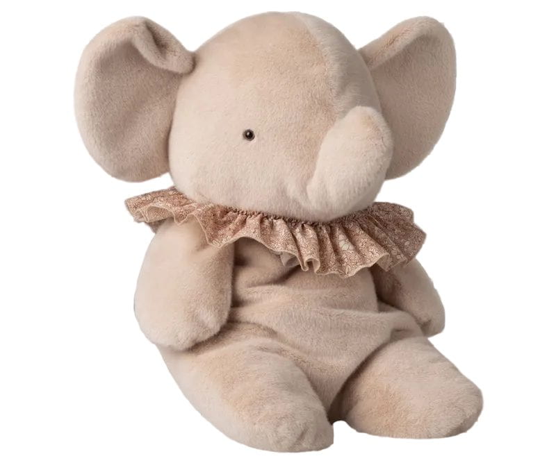 A beige plush elephant toy with a small black bead eye and a glittery rose-gold ruffled collar, shown against a gray and white checkered transparency background.