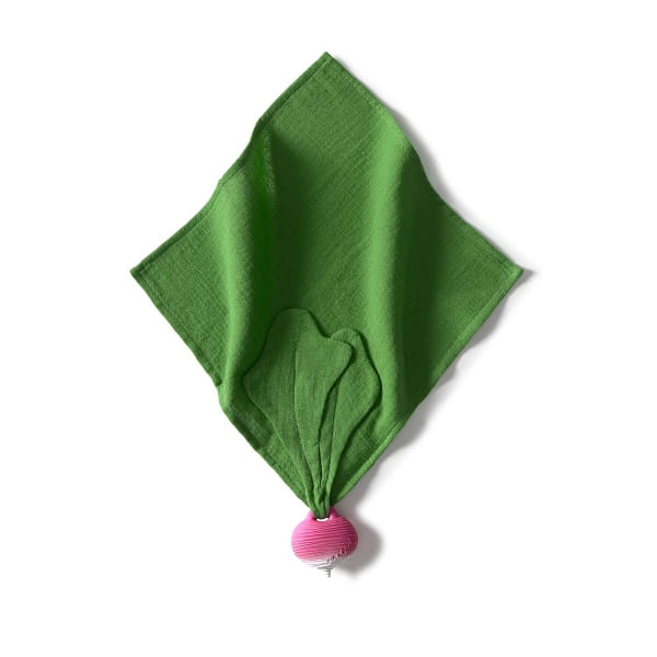 Green knotted fabric with a pink radish on a white background