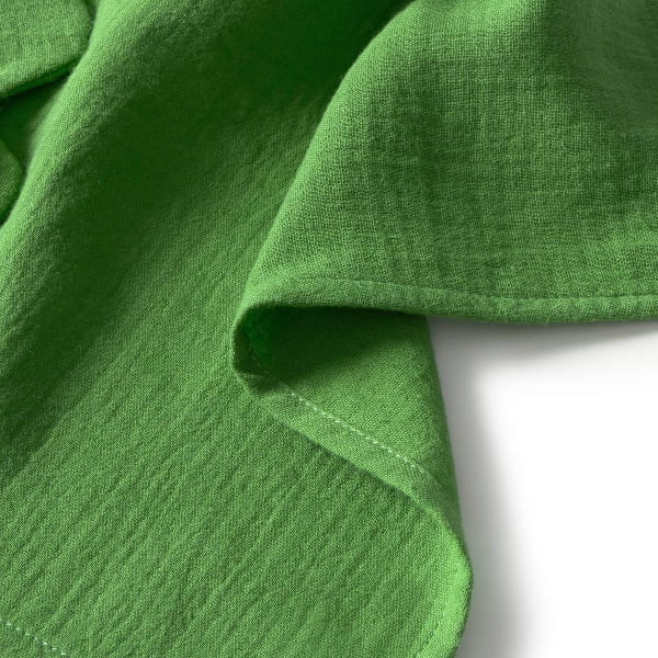 Close-up of green fabric with a white background