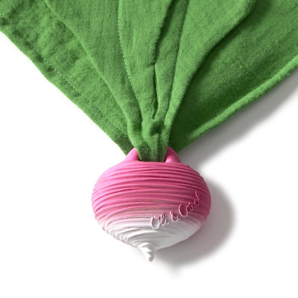 Pink and white silicone product with green fabric draped over it on a white background