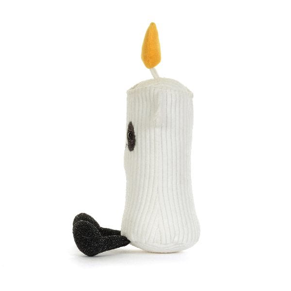 A white ribbed plush candle toy with a yellow flame on top, a small black embroidered eye, and a black textured foot, photographed on a clean white background.