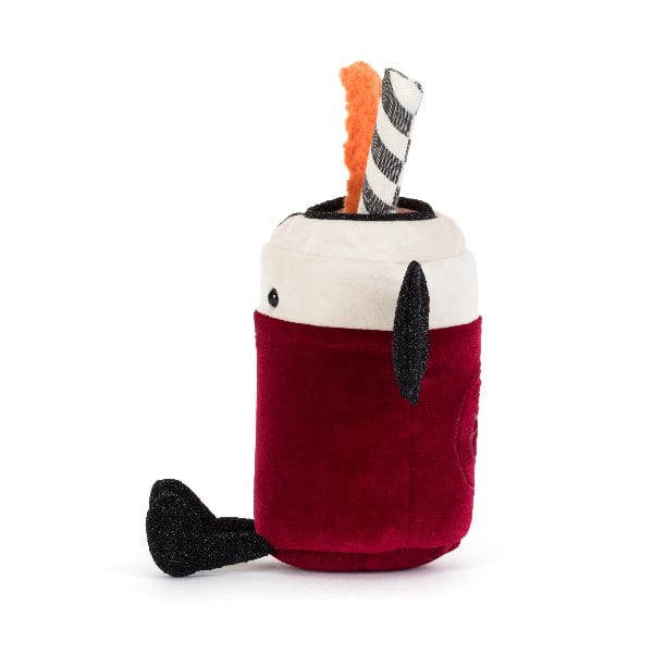 A plush toy shaped like a soda pop, featuring a deep red velvet body, a cream fabric rim, black ears and nose, and two plush accessories sticking out of the top: an orange textured piece and a gray-and-white striped piece.
