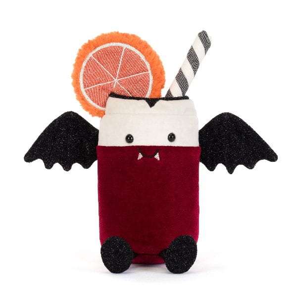 A plush vampire drink toy on a white background. The toy features a deep red body, a white head, black bat wings, a black-and-white striped straw, a glittery orange slice garnish, and small black feet.
