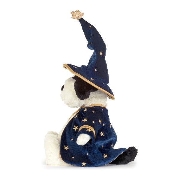 A plush dog toy dressed as a wizard, featuring a navy blue velvet robe and pointed hat with gold embroidered stars and a crescent moon, set against a plain white background.