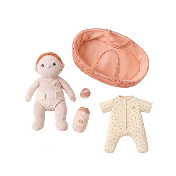 Baby doll with accessories including a hat, bottle, and onesie on a white background