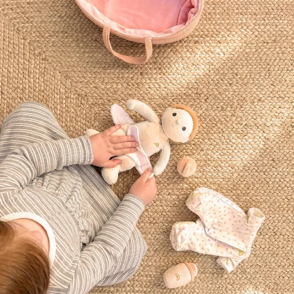 Child playing with a plush toy on a textured floor