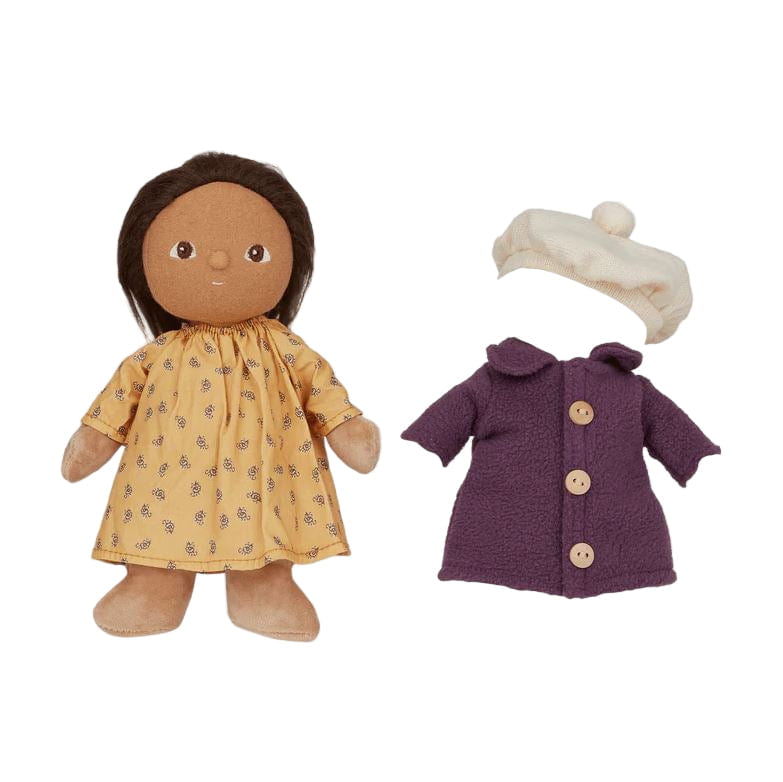 Doll with yellow dress, purple coat, and white hat on a light gray background