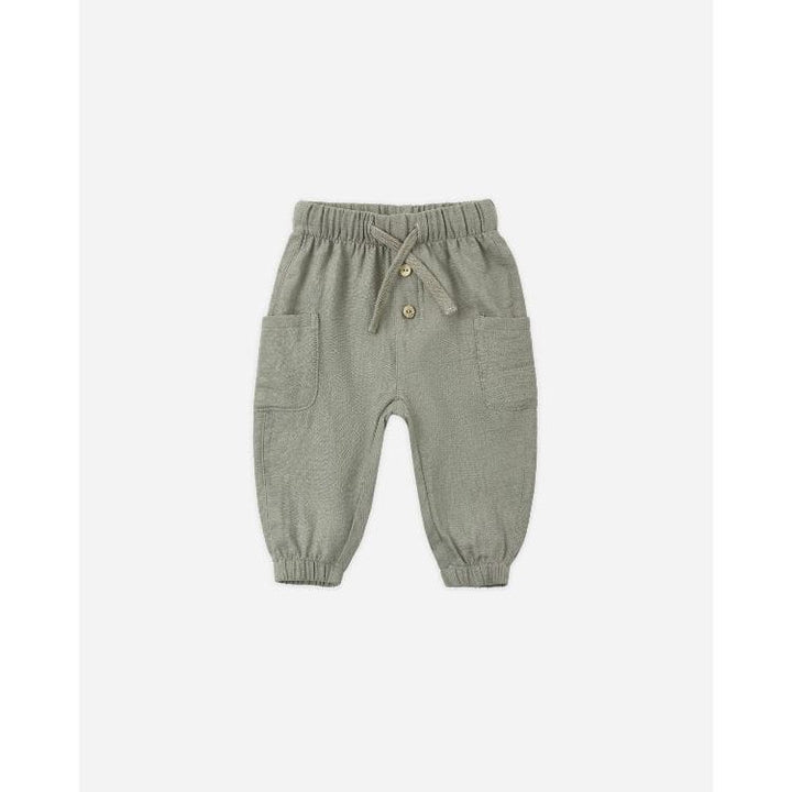 A pair of baby jogger pants in sage green, featuring an elastic waistband with a drawstring, two front patch pockets, and elastic cuffs at the ankles, shown against a plain light gray background.