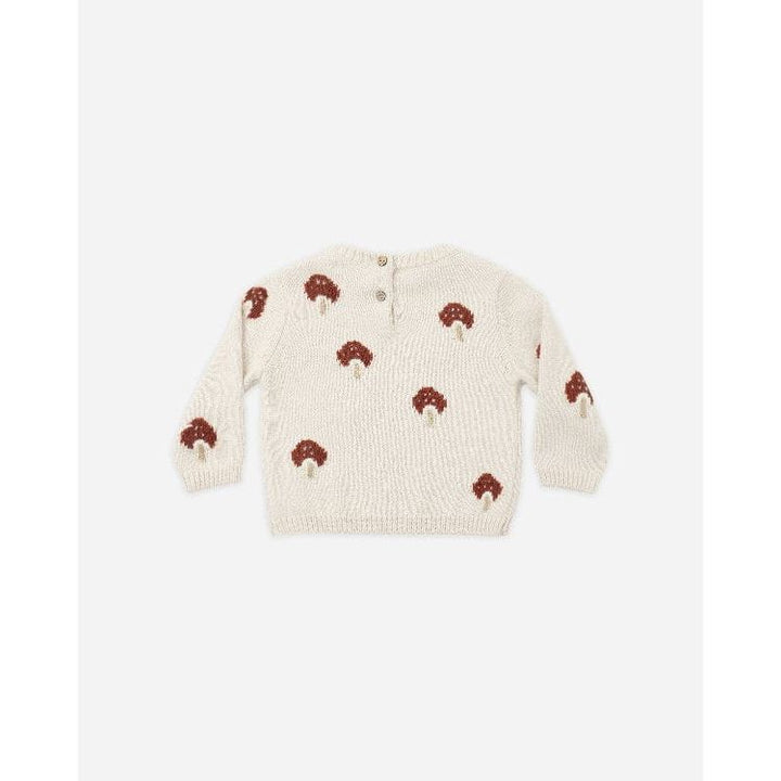 An off-white knit baby sweater featuring an all-over pattern of brown and cream embroidered mushrooms, laid flat against a light gray background.