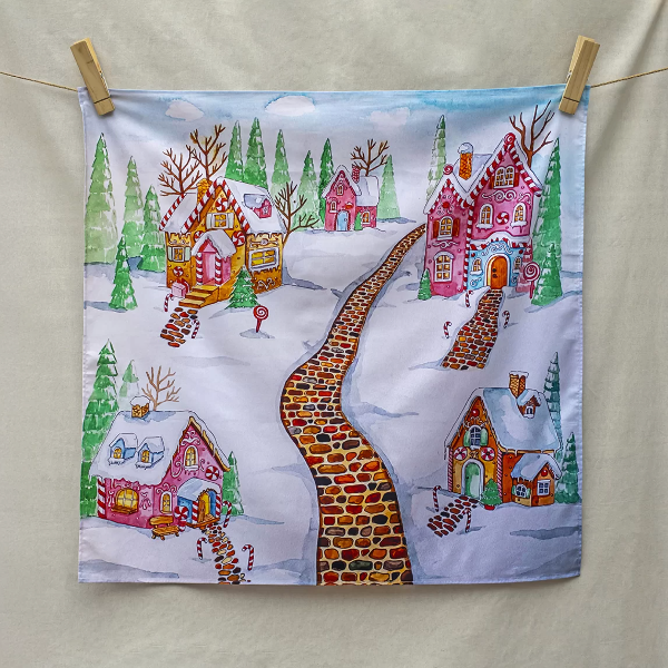 Colorful fabric print of a winter scene with gingerbread houses and a path.