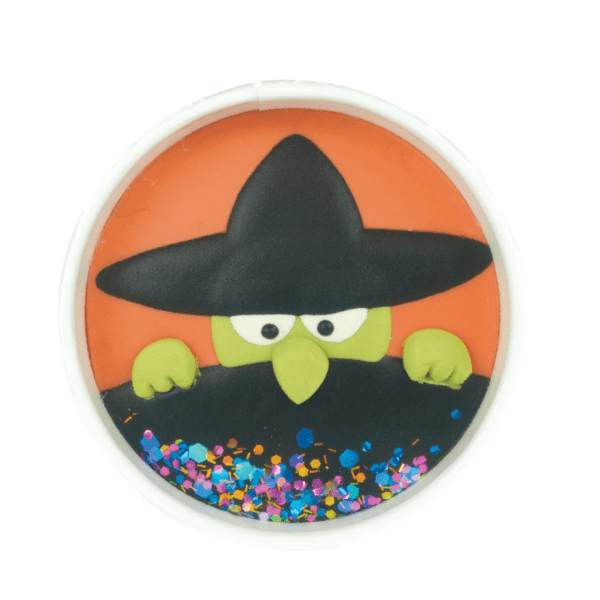 Circular cookie with a cartoon witch design on an orange background
