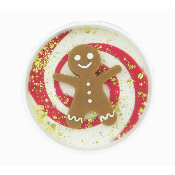 Gingerbread man design on a round white plate with gold glitter