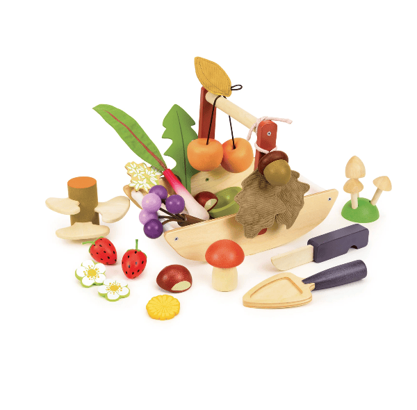 Set of wooden toy fruits, vegetables, and tools on a white background