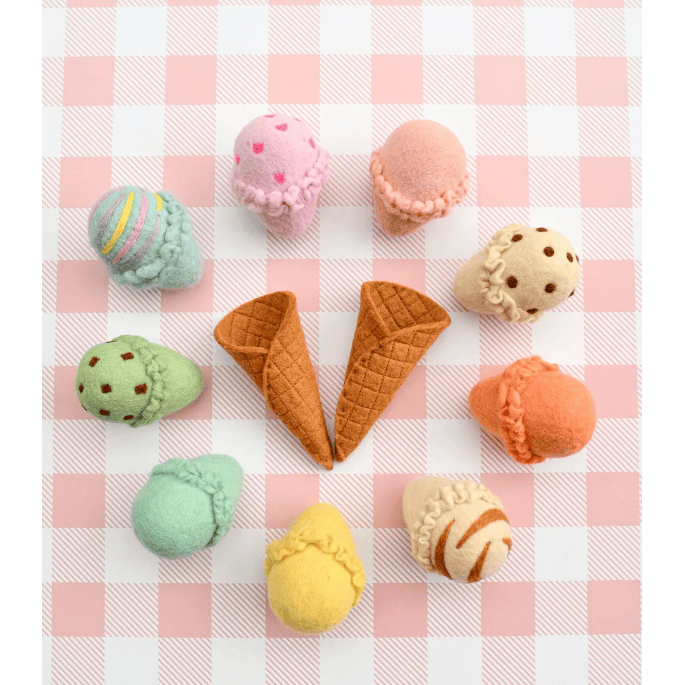 Pastel-colored ice cream cones and cookies on a pink and white checkered background