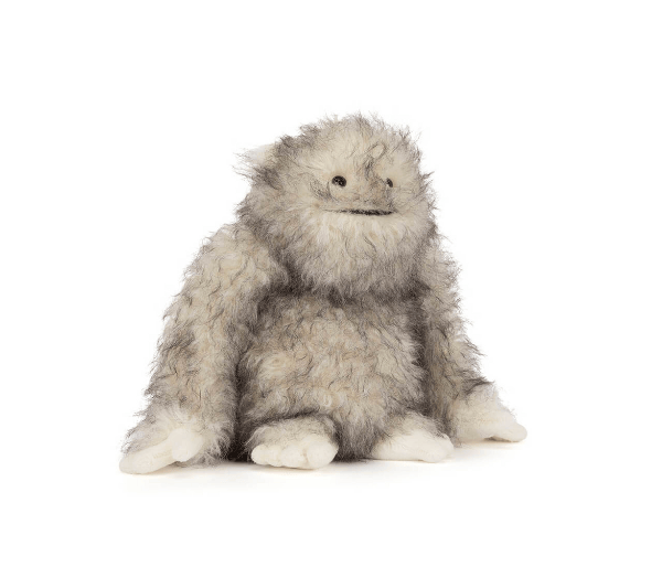 Plush toy resembling a fluffy creature on a white background
