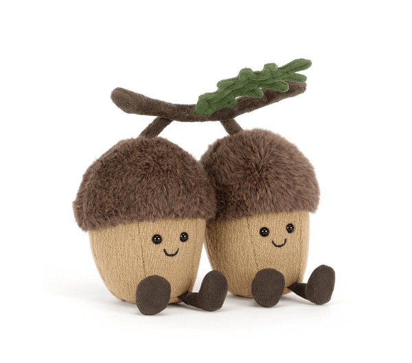 Two plush acorns with faces on a white background