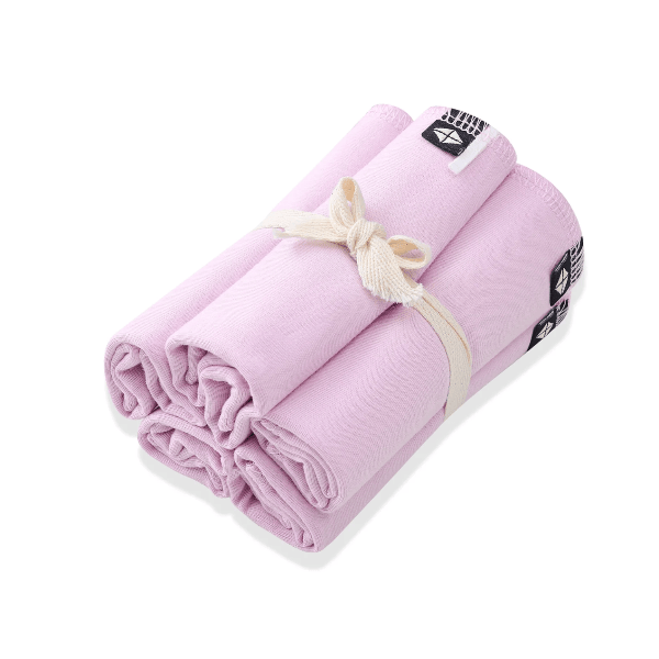 Rolled-up pink towel with a white strap on a white background