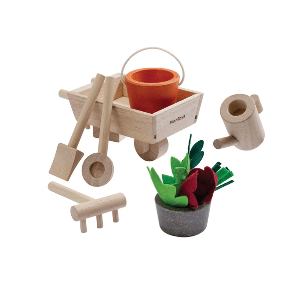 Set of wooden gardening tools and plants on a white background
