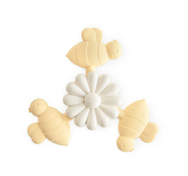 A silicone baby teething toy shaped like a bee arranged around a white daisy in the center, on a clean white background.