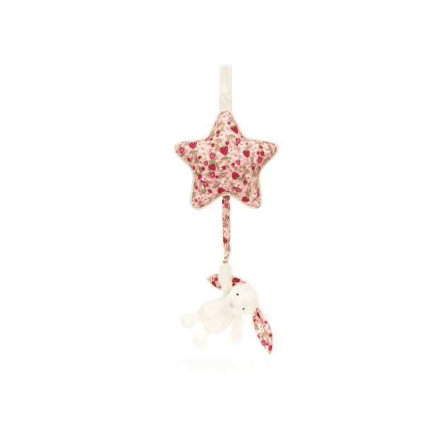 An ivory plush bunny musical pull hanging from a plush star in a floral and strawberry pink print.