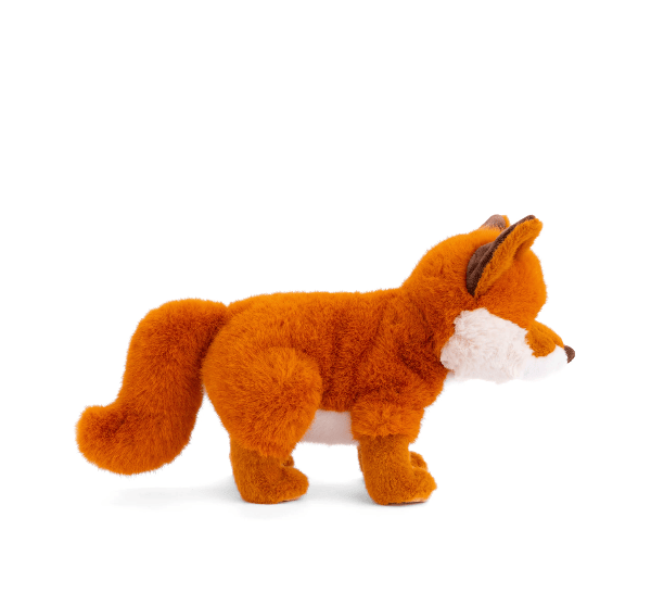 A plush toy fox in profile, made of soft orange-brown faux fur with a white chest and muzzle, standing on a white background.