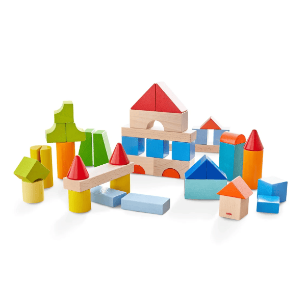A set of colorful wooden building blocks in the shape of a house and trees.