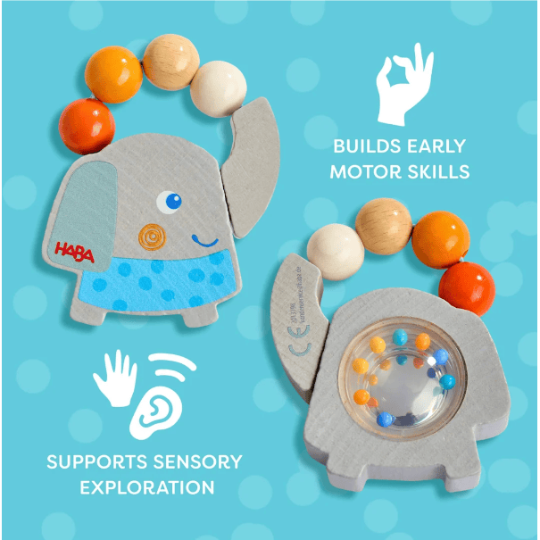 HABA wooden elephant sensory toy shown in two views on a bright blue background with white text and icons. One view shows the elephant face with a beaded loop of orange, white, and natural wood beads; the other shows the elephant side with a clear window revealing colorful rolling balls.