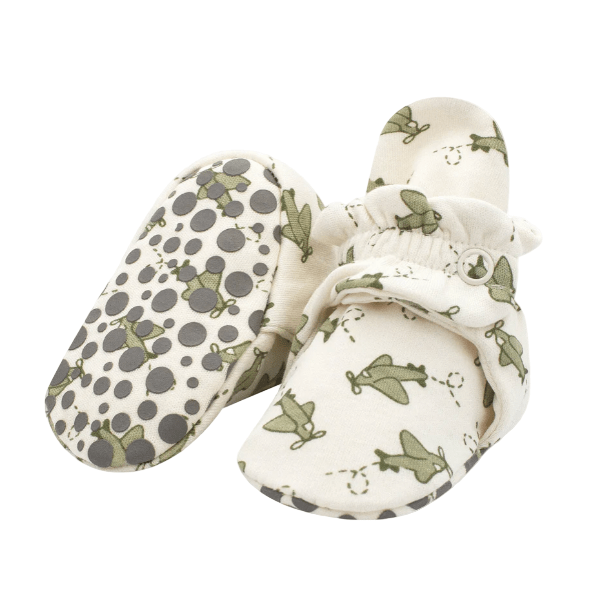 Pair of baby shoes with green butterfly pattern on a white background