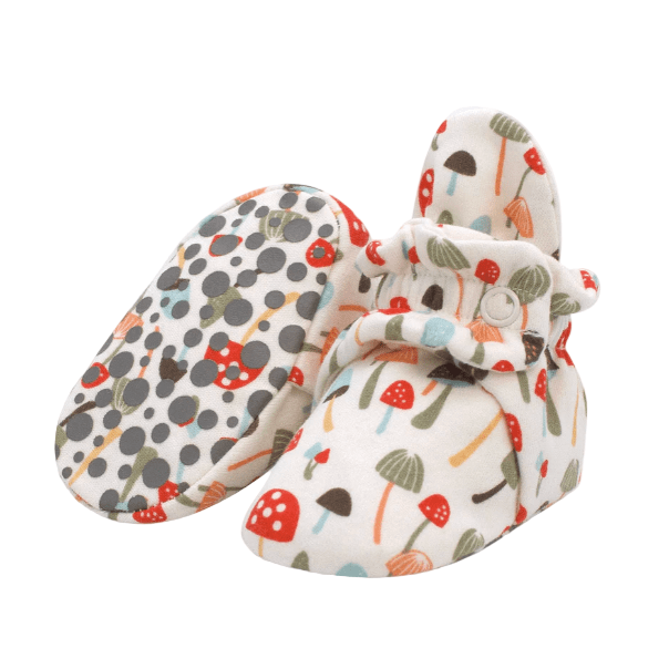 Pair of baby booties with mushroom pattern on a white background