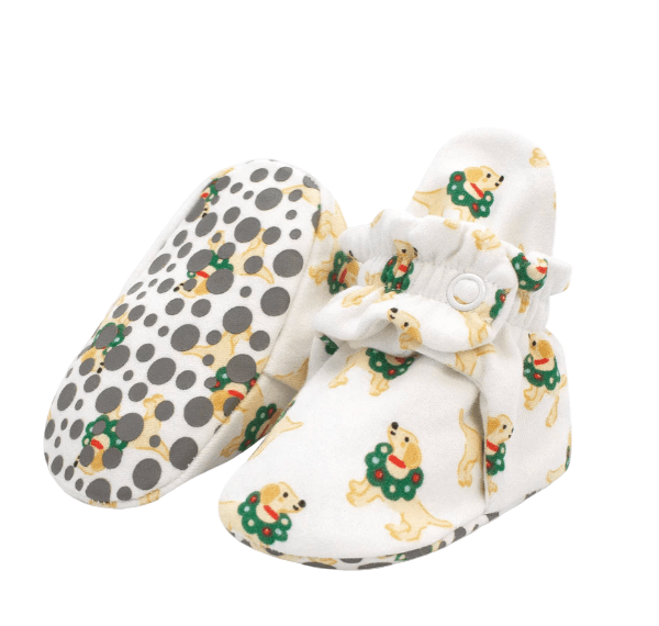 Pair of baby shoes with polka dot and dog pattern on a white background