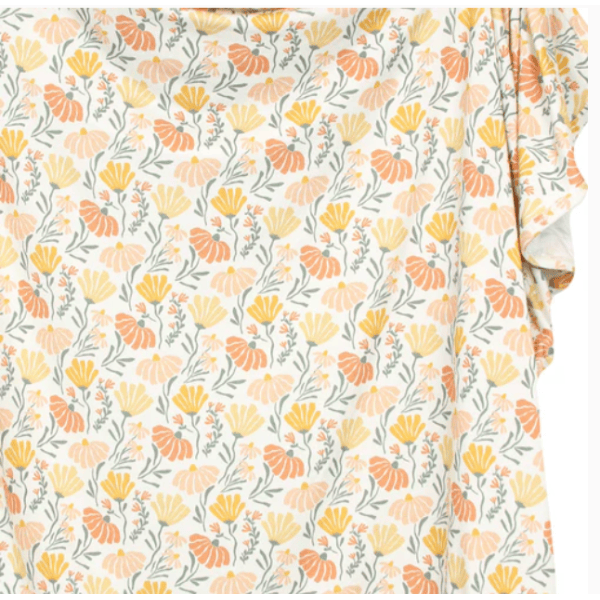 Floral patterned fabric with orange and yellow flowers on a white background