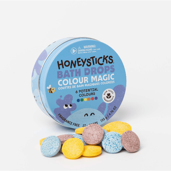 Honeysticks Bath Drops Colour Magic packaging with colorful bath bombs on a white background