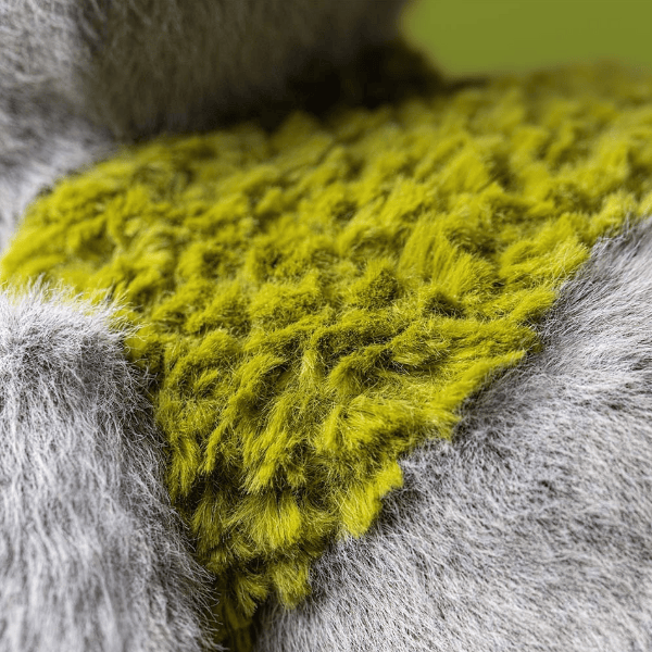 Close-up of a textured green fabric on a gray surface