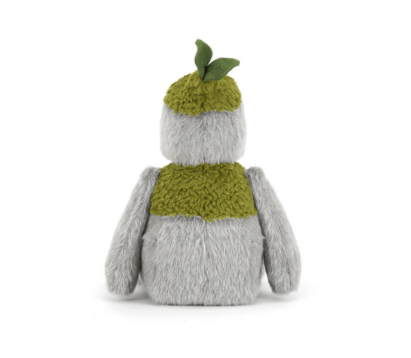 Plush toy resembling a creature with a green scarf and leaf on a white background