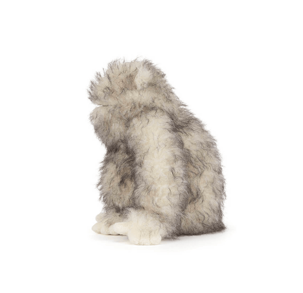 Plush toy resembling a wolf on a white background
