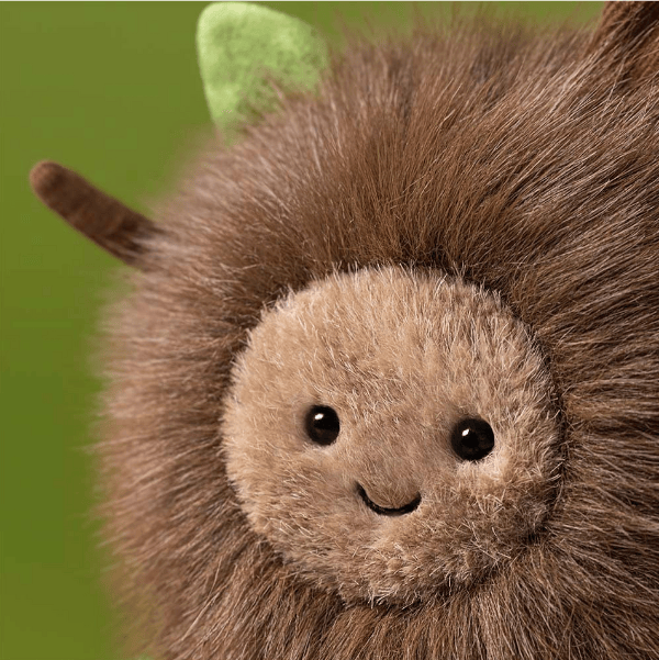 Plush toy with a green leaf on a green background