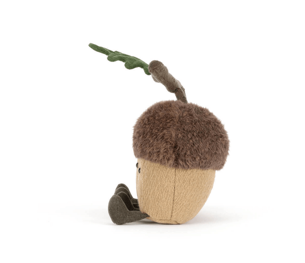 Toy acorn with a small creature inside on a white background