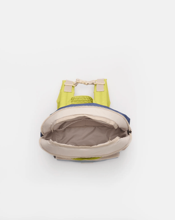 Open green and beige bag on a white background