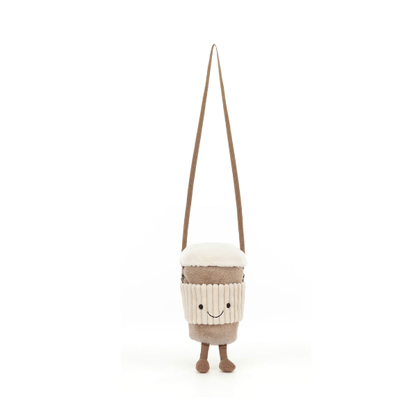 A plush coffee cup crossbody bag with a smiling face, featuring a cream-colored striped body, a white top, and a brown shoulder strap, shown against a plain white background.