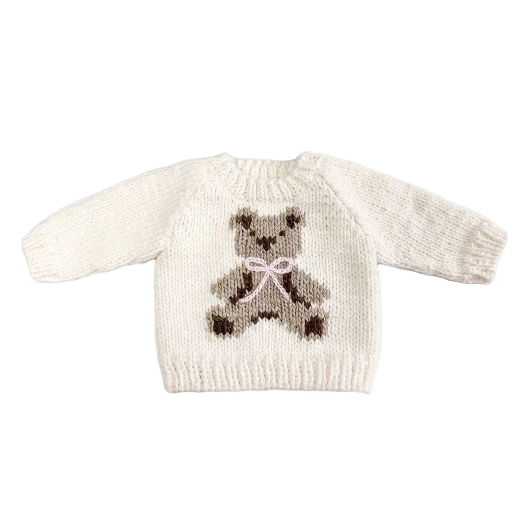 Knitted sweater with a teddy bear design on a white background