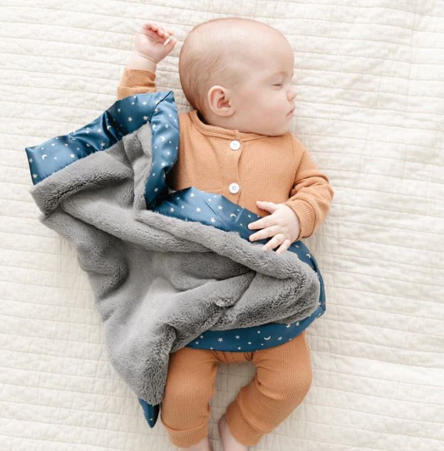 baby sleeping on a play mat 
