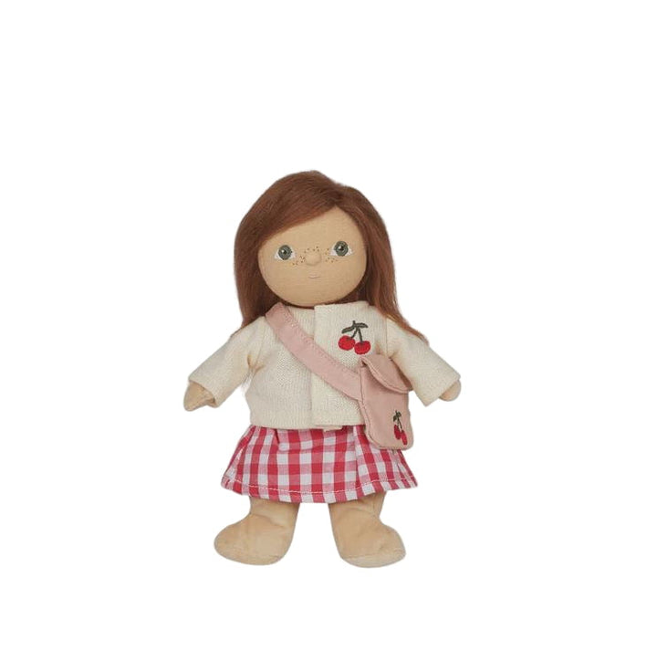 Doll with a checkered skirt and cherry-themed jacket on a white background