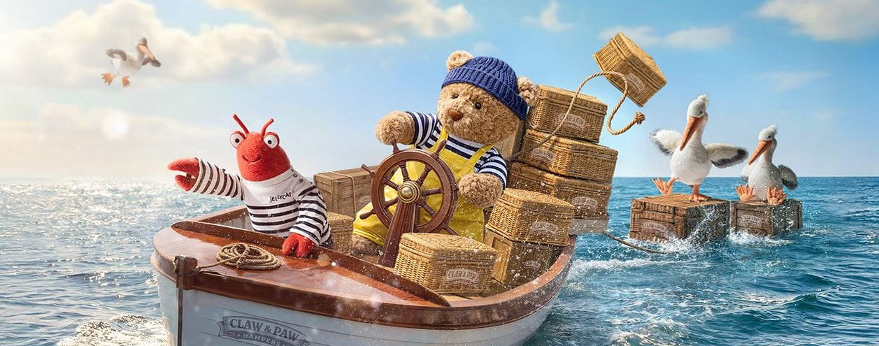 Animated scene with a teddy bear captain steering a boat with cargo, surrounded by birds on another boat.