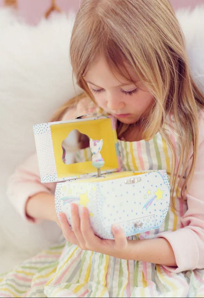 Child playing with a small toy box on a white background